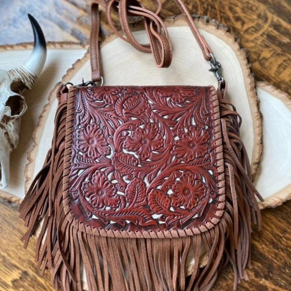 Western tooled leather crossbody fringe purse.
